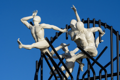 Flight of the Langoustine, by Pierre Diamantopoulo MRSS. It is made of four life-size bronze figures flying through a steel grid. It was inspired by a discarded and mangled lobster pot that the artist had found on Brighton beach. In his imagination, the washed-up object that had seemingly helped the lobsters escape, translated itself into a wider story of human exodus and release – a dash for freedom. Diamantopoulo describes the figures as “at once profound, frivolous and boisterous, occupying the air like a flock of birds and inspired by modern dance choreography”. Bronze casting at Milwyn Foundry and fabrication of the steel grid and assembly by Art Fabrications. The sculpture weighs 2.2 tonnes and measures approximately 3.5 metres high and 3 meters wide. Flight of the Langoustine was inaugurated on the Hove Plinth on 17 September 2023. Flight of the Langoustine, by Pierre Diamantopoulo MRSS. It is made of four life-size bronze figures flying through a steel grid. It was inspired by a discarded and mangled lobster pot that the artist had found on Brighton beach. In his imagination, the washed-up object that had seemingly helped the lobsters escape, translated itself into a wider story of human exodus and release – a dash for freedom. Diamantopoulo describes the figures as “at once profound, frivolous and boisterous, occupying the air like a flock of birds and inspired by modern dance choreography”. Bronze casting at Milwyn Foundry and fabrication of the steel grid and assembly by Art Fabrications. The sculpture weighs 2.2 tonnes and measures approximately 3.5 metres high and 3 meters wide. Flight of the Langoustine was inaugurated on the Hove Plinth on 17 September 2023.