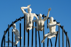 Flight of the Langoustine, by Pierre Diamantopoulo MRSS. It is made of four life-size bronze figures flying through a steel grid. It was inspired by a discarded and mangled lobster pot that the artist had found on Brighton beach. In his imagination, the washed-up object that had seemingly helped the lobsters escape, translated itself into a wider story of human exodus and release – a dash for freedom. Diamantopoulo describes the figures as “at once profound, frivolous and boisterous, occupying the air like a flock of birds and inspired by modern dance choreography”. Bronze casting at Milwyn Foundry and fabrication of the steel grid and assembly by Art Fabrications. The sculpture weighs 2.2 tonnes and measures approximately 3.5 metres high and 3 meters wide. Flight of the Langoustine was inaugurated on the Hove Plinth on 17 September 2023.