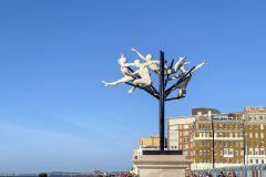 Flight of the Langoustine, by Pierre Diamantopoulo MRSS. It is made of four life-size bronze figures flying through a steel grid. It was inspired by a discarded and mangled lobster pot that the artist had found on Brighton beach. In his imagination, the washed-up object that had seemingly helped the lobsters escape, translated itself into a wider story of human exodus and release – a dash for freedom. Diamantopoulo describes the figures as “at once profound, frivolous and boisterous, occupying the air like a flock of birds and inspired by modern dance choreography”. Bronze casting at Milwyn Foundry and fabrication of the steel grid and assembly by Art Fabrications. The sculpture weighs 2.2 tonnes and measures approximately 3.5 metres high and 3 meters wide. Flight of the Langoustine was inaugurated on the Hove Plinth on 17 September 2023. Flight of the Langoustine, by Pierre Diamantopoulo MRSS. It is made of four life-size bronze figures flying through a steel grid. It was inspired by a discarded and mangled lobster pot that the artist had found on Brighton beach. In his imagination, the washed-up object that had seemingly helped the lobsters escape, translated itself into a wider story of human exodus and release – a dash for freedom. Diamantopoulo describes the figures as “at once profound, frivolous and boisterous, occupying the air like a flock of birds and inspired by modern dance choreography”. Bronze casting at Milwyn Foundry and fabrication of the steel grid and assembly by Art Fabrications. The sculpture weighs 2.2 tonnes and measures approximately 3.5 metres high and 3 meters wide. Flight of the Langoustine was inaugurated on the Hove Plinth on 17 September 2023.