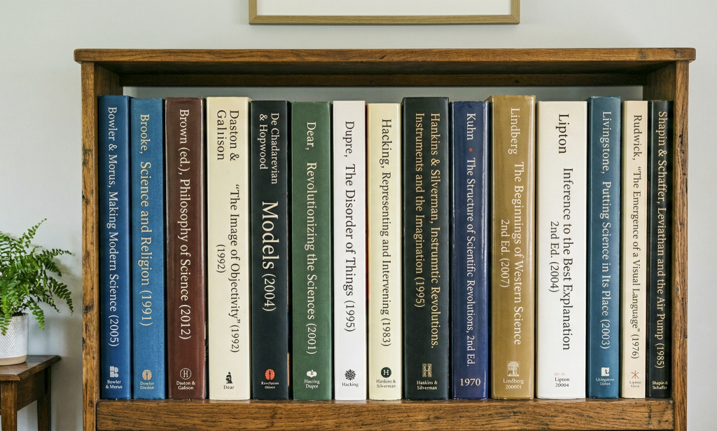 Simulated bookshelf showing HPS reading list. (Credit: NanoBanana)